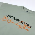 تیشرت مردانه keep your distance رنگ مغز پسته ای روشن